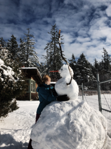 A student builds a snowman